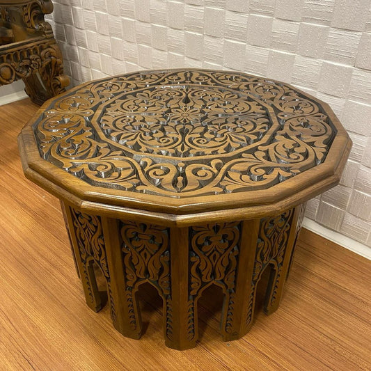 Round walnut wood coffee table with intricate hand-carved details